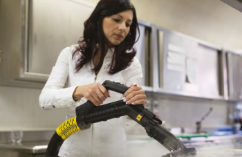 Image demonstrating the use of Duplex steam cleaning machines for efficient and hygienic cleaning of chopping boards in commercial kitchens.