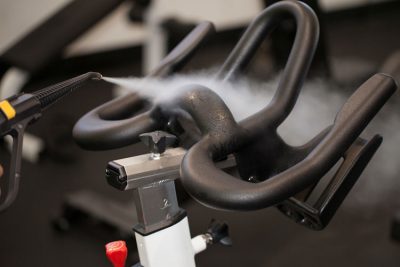 Image showcasing Duplex Cleaning Machines' steam cleaning technology for sanitising, disinfecting, and deep cleaning exercise bicycles in gym and fitness club environments.
