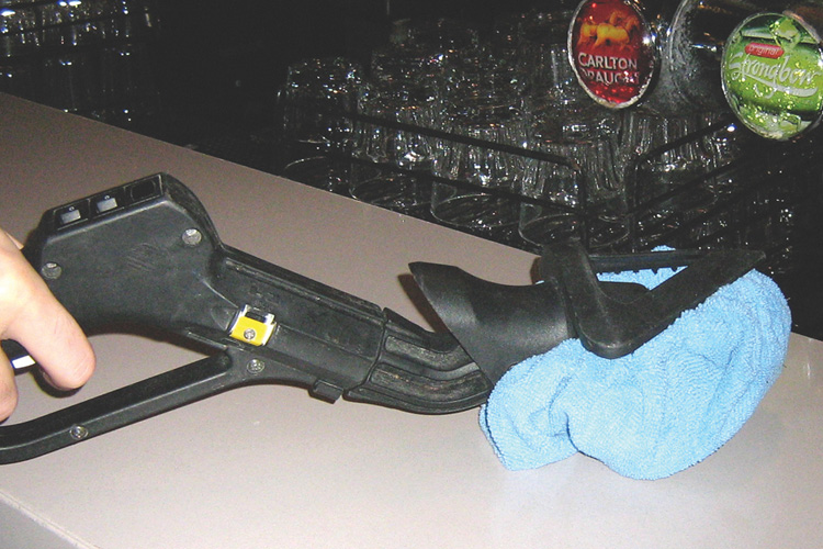 Image showcasing Duplex Cleaning Machines' method for efficiently cleaning sticky bar tops in nightclubs using high-temperature steam to melt away grime and sanitize surfaces.