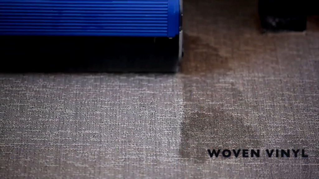 Duplex vinyl floor machine is cleaning woven vinyl
