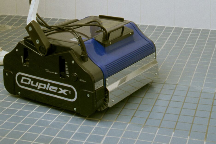 Duplex floor scrubber is cleaning the tile.