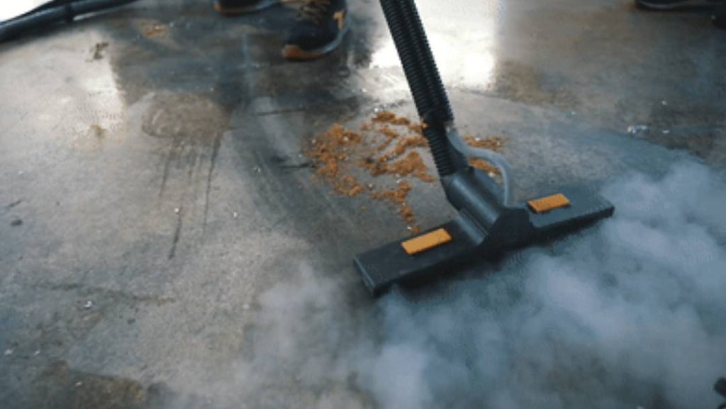 Duplex steam vacuum cleaner cleaning the concrete floor