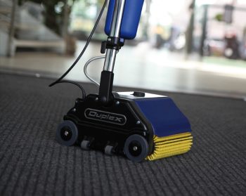 Duplex carpet cleaning machine sanitising carpeted flooring in a fitness centre near the entrance.