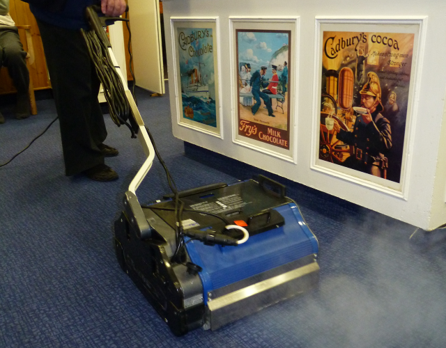 Duplex carpet machine cleaning corridor carpet in a hospitality setting with low noise steam technology.