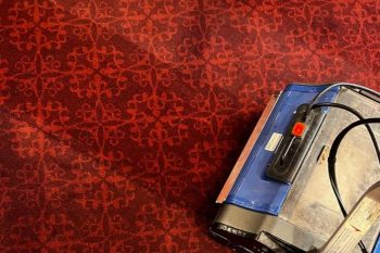 Duplex crb carpet cleaning machine on patterned red carpet in a commercial setting