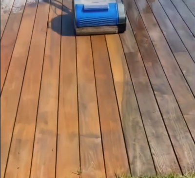 Duplex commercial floor cleaning machine restoring timber decking by removing surface grime.