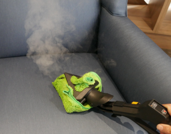 Steam cleaning a fabric chair in an aged care facility for daily hygiene maintenance.