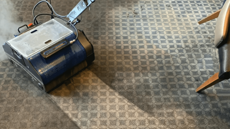 Duplex commercial steam floor cleaner effectively cleaning a carpeted floor with steam.