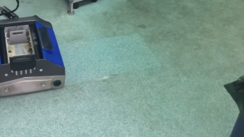 Duplex machine cleaning carpet in a commercial office setting, showing quiet and efficient operation for professional use.