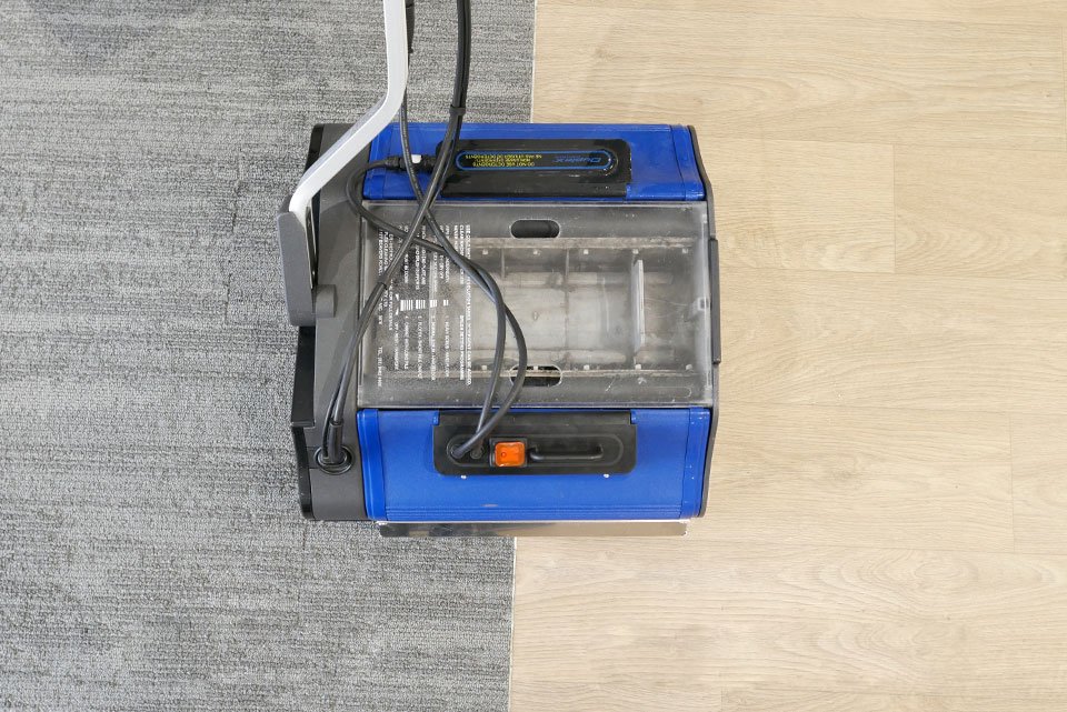 Duplex machine cleaning transition area between carpet and hard floor surface.
